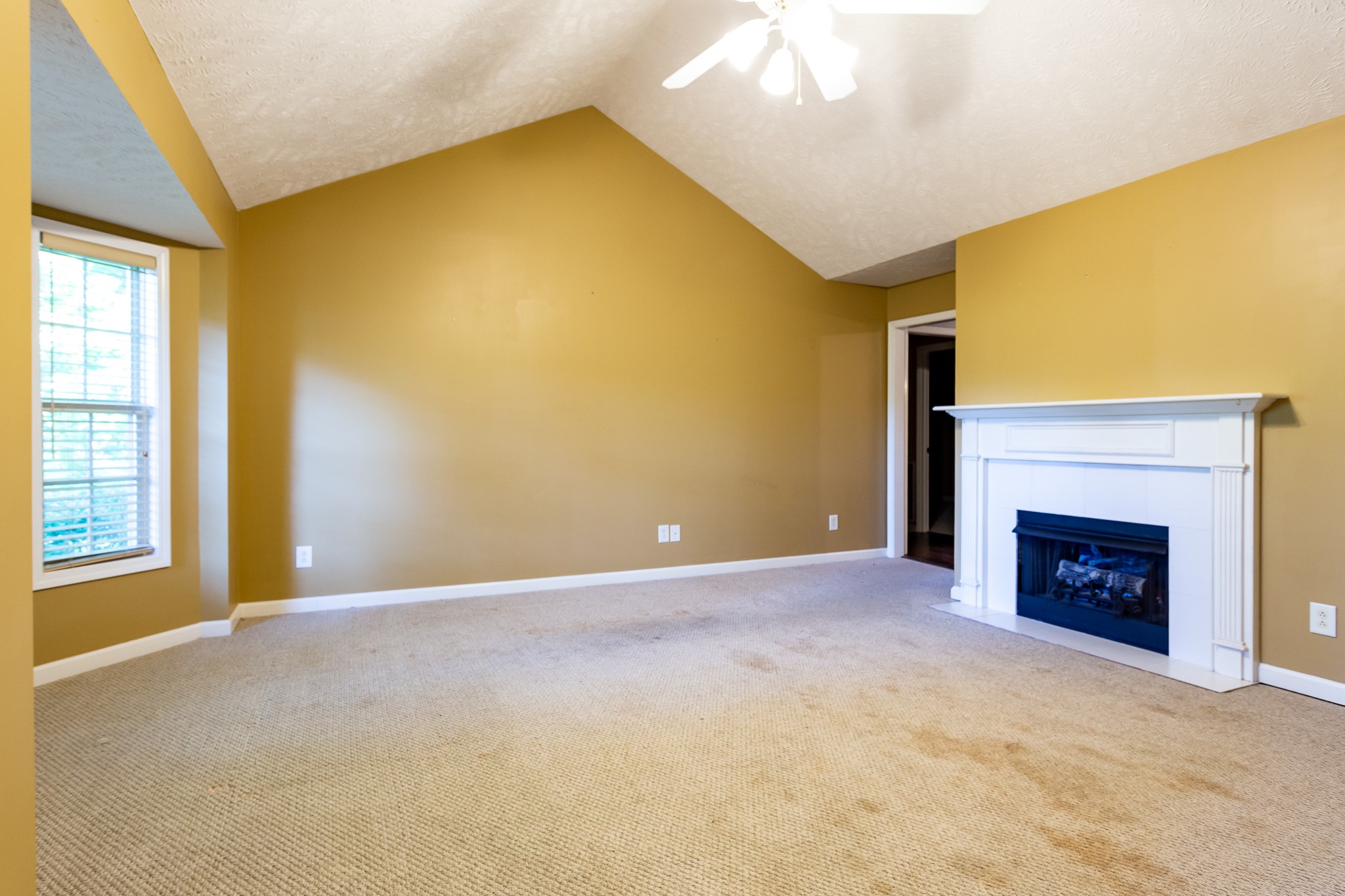 1649 Gratton Road Clarksville, TN 37043 - Photo 2 of 23 a view of an empty room with a fireplace and a window
