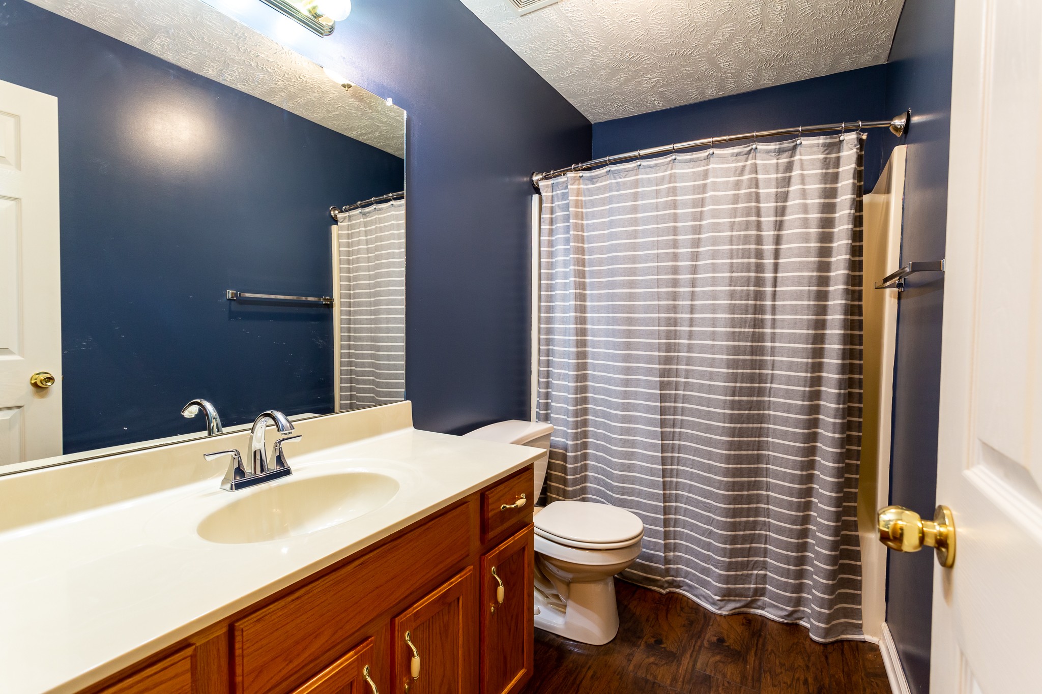 1649 Gratton Road Clarksville, TN 37043 - Photo 15 of 23 a bathroom with a sink a toilet and shower curtain