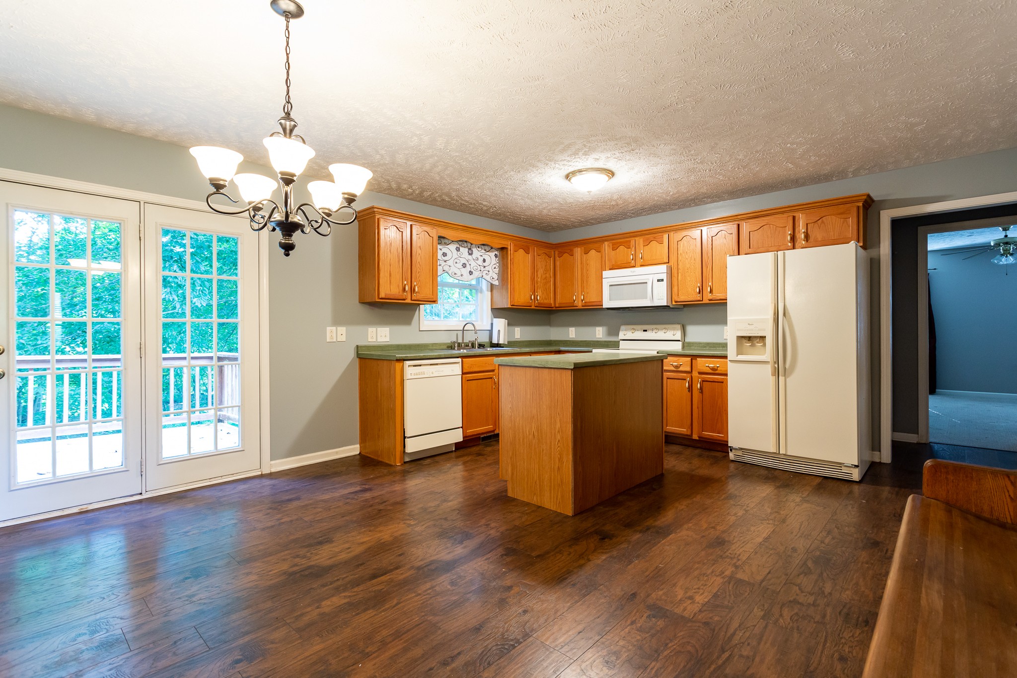 1649 Gratton Road Clarksville, TN 37043 - Photo 4 of 23 a kitchen with stainless steel appliances granite countertop a refrigerator a sink dishwasher a stove and white countertops with wooden floor