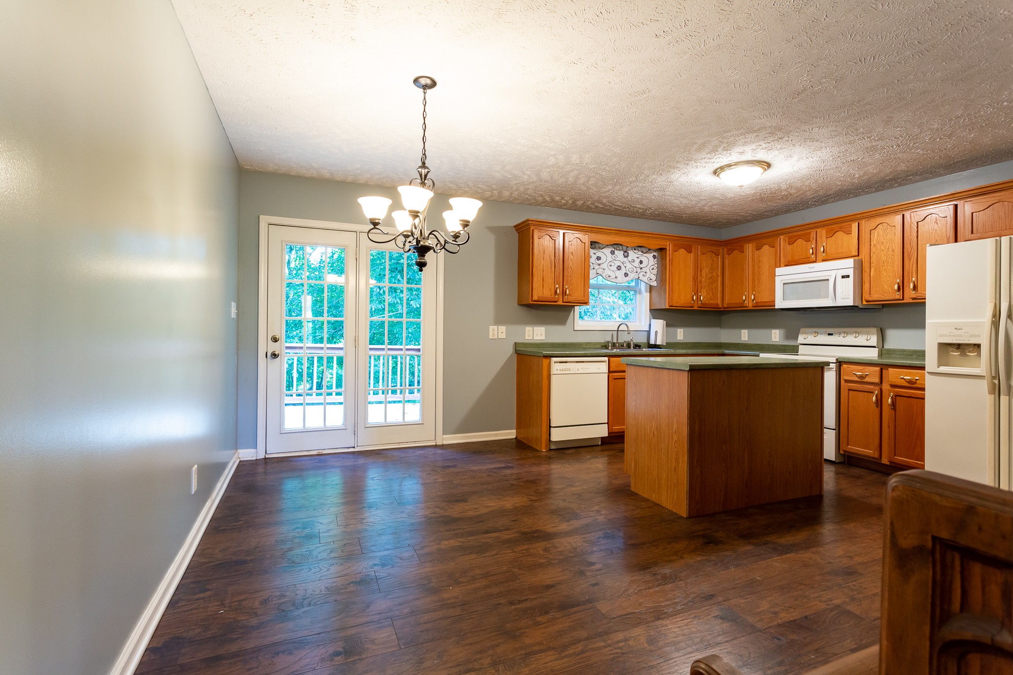 1649 Gratton Road Clarksville, TN 37043 - Photo 6 of 23 a kitchen with kitchen island granite countertop a stove a sink a refrigerator dining table and chairs