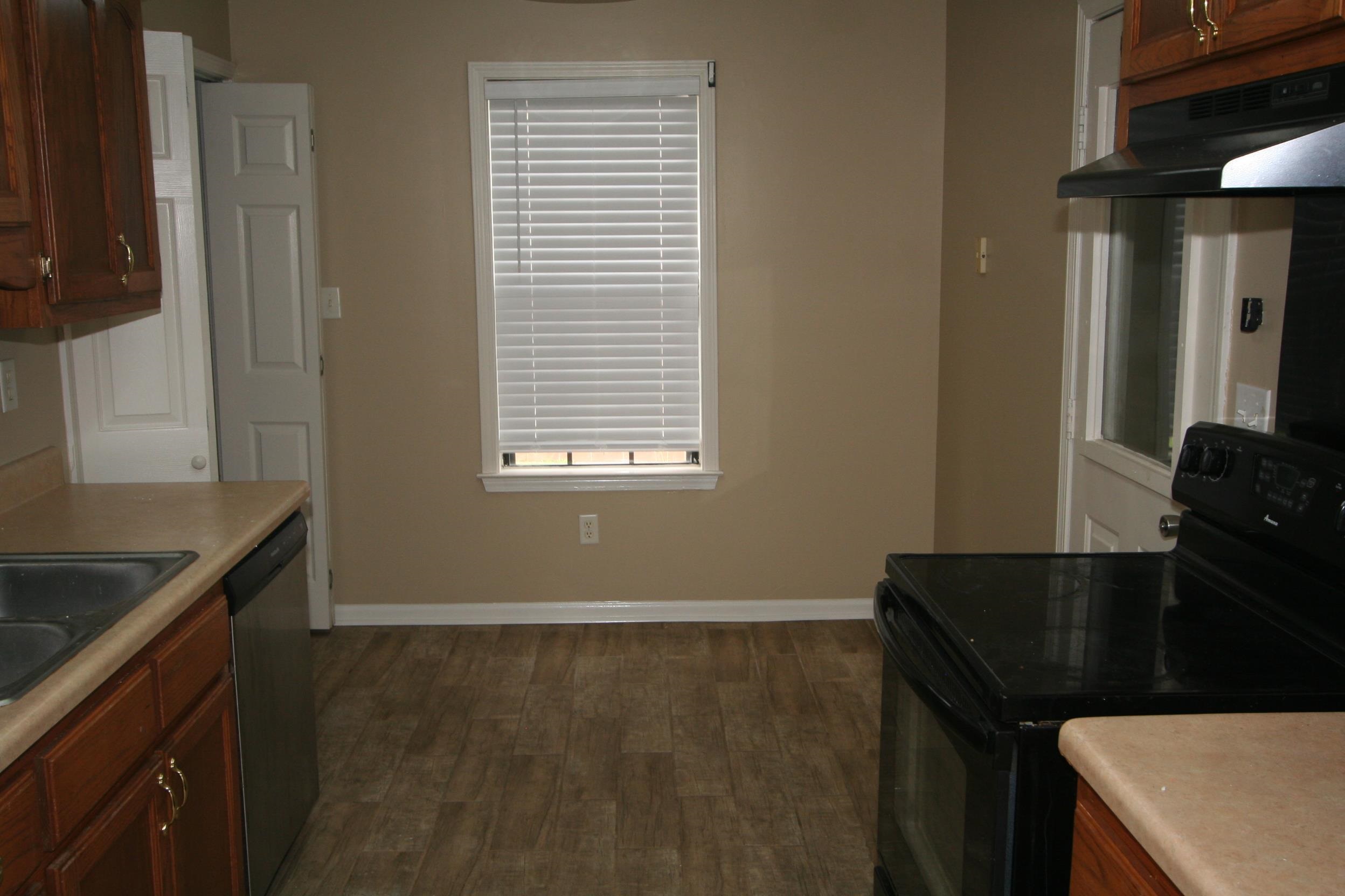 9793 Riggan Drive Olive Branch, MS 38654 - Photo 5 of 7 a kitchen with a sink a stove and a refrigerator