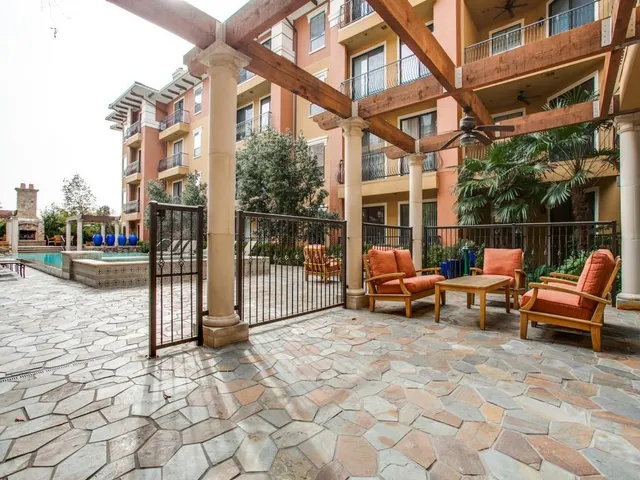 a view of a building with a bench in patio