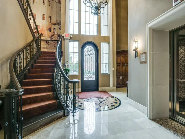 a view of an entryway with wooden floor windows and a livingroom