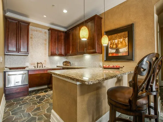 a kitchen with stainless steel appliances granite countertop a sink and a stove