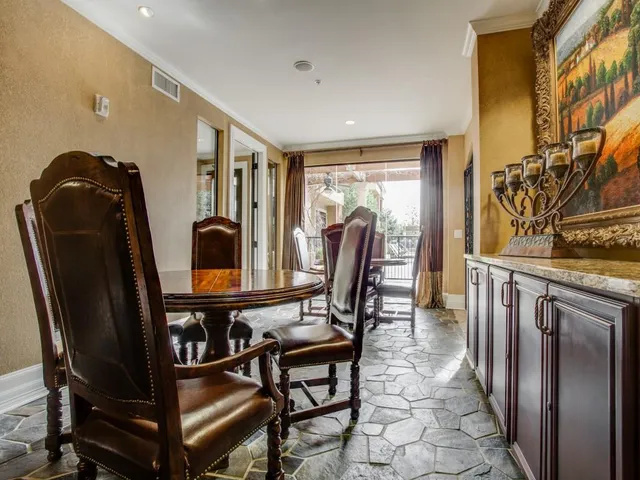 a view of a hallway with furniture and a window