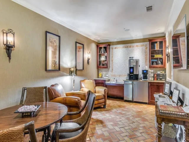 a living room with furniture kitchen view and a window