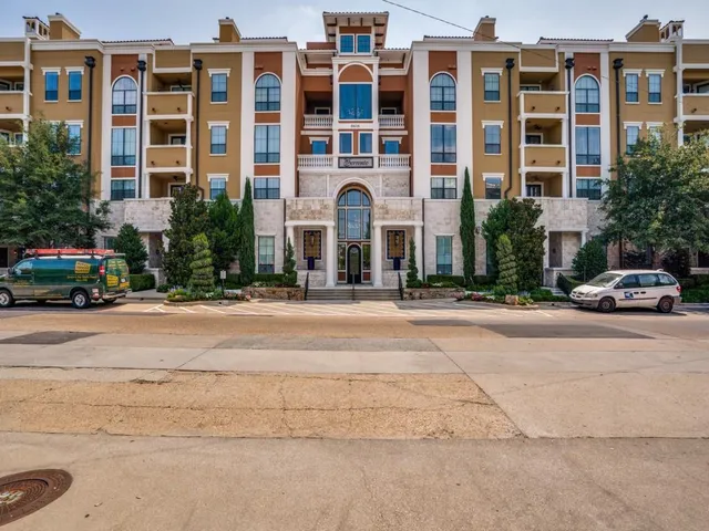 a couple of cars parked in front of building