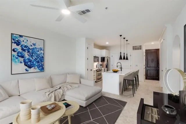 a living room with furniture and kitchen view