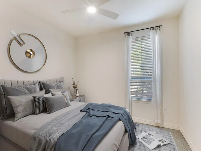 a bedroom with a bed and a window