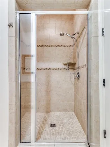 a bathroom with a glass shower door