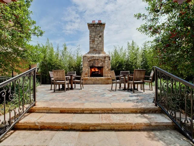 a view of a swimming pool with a couches and tables