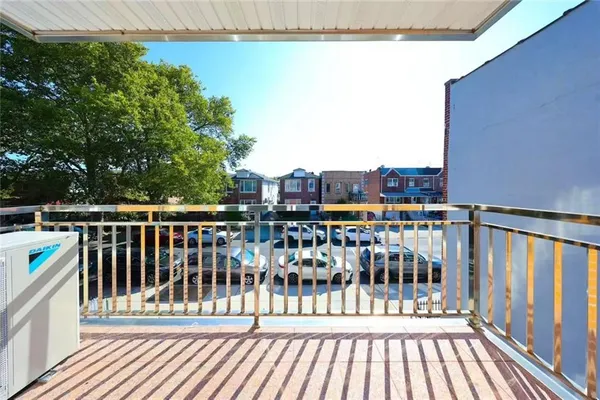 a view of a balcony with wooden floor and fence