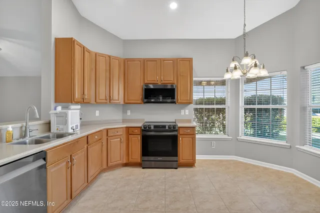 a kitchen with stainless steel appliances granite countertop a stove and a sink