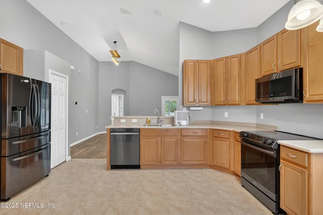 a kitchen with a sink stove and refrigerator