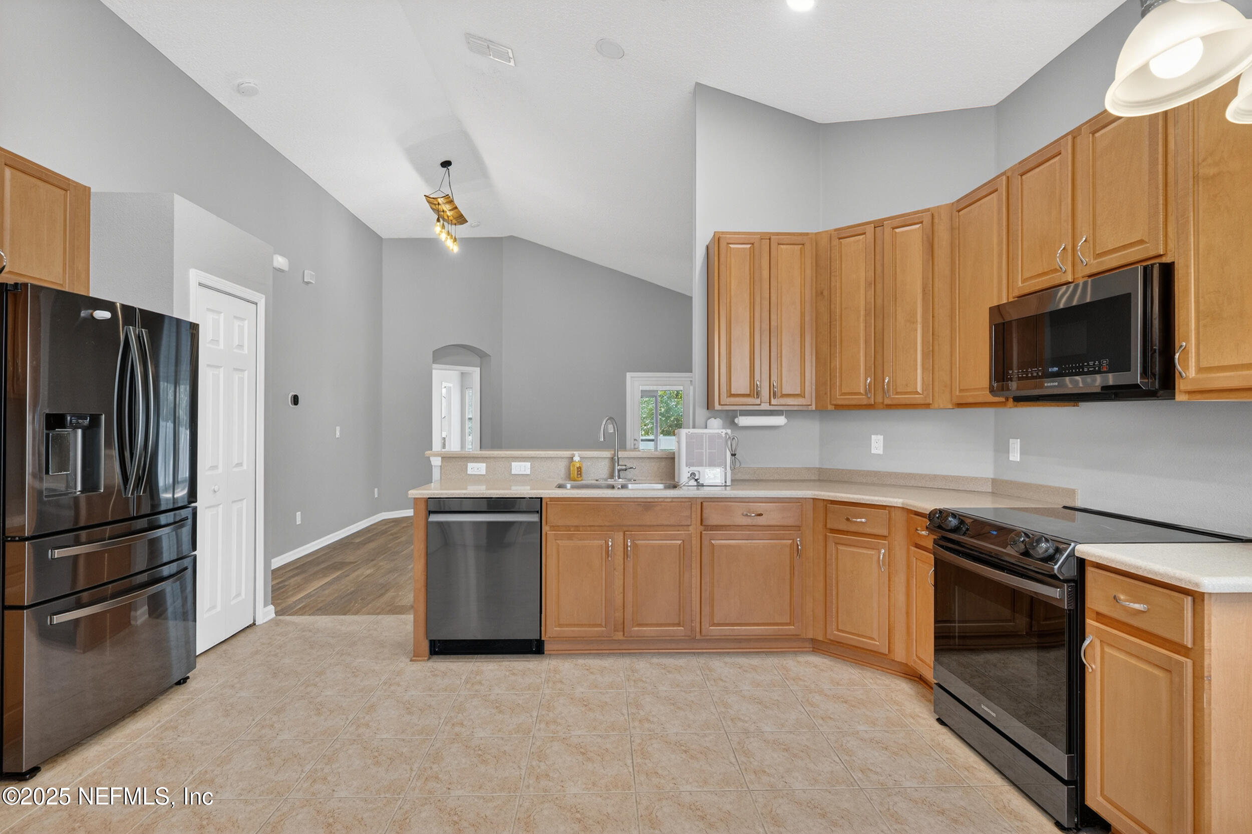 1165 Carmona Place St. Augustine, FL 32092 - Photo 16 of 31 a kitchen with a sink stove and refrigerator
