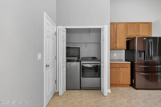 a kitchen with stainless steel appliances granite countertop a refrigerator and a stove