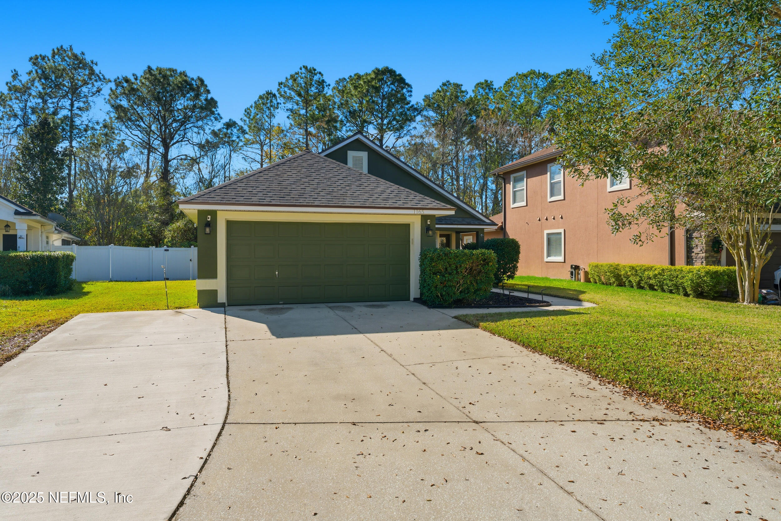 1165 Carmona Place St. Augustine, FL 32092 - Photo 2 of 31 a front view of a house with a yard and garage
