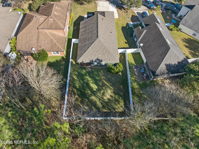 an aerial view of a house with a yard