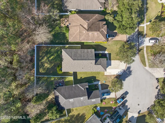 an aerial view of a house with garden space and sitting area