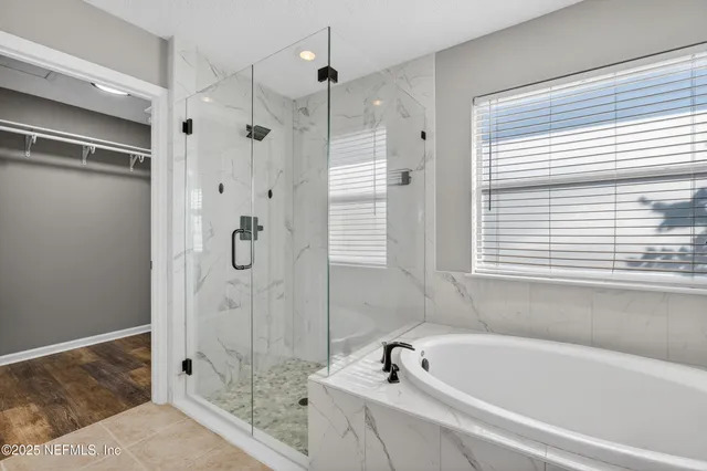 a bathroom with a tub and a shower