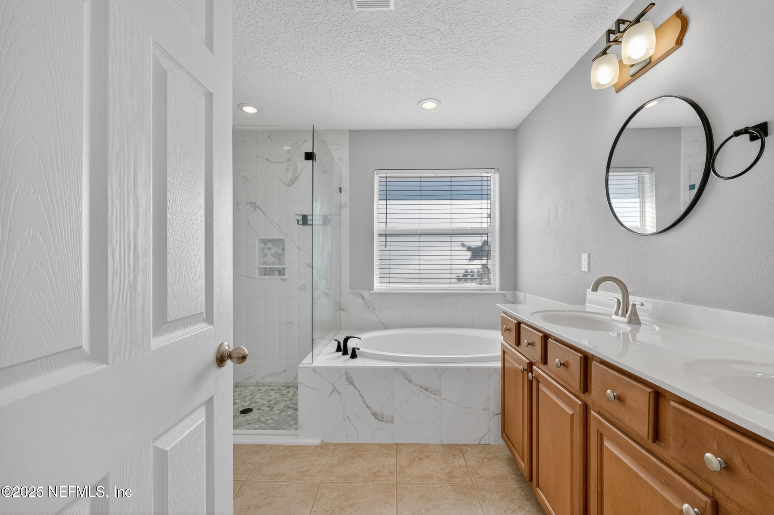 1165 Carmona Place St. Augustine, FL 32092 - Photo 8 of 31 a bathroom with a tub sink and mirror