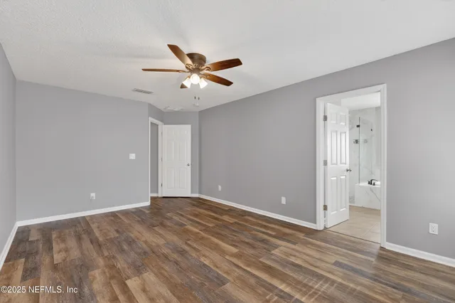 a view of an empty room and wooden floor