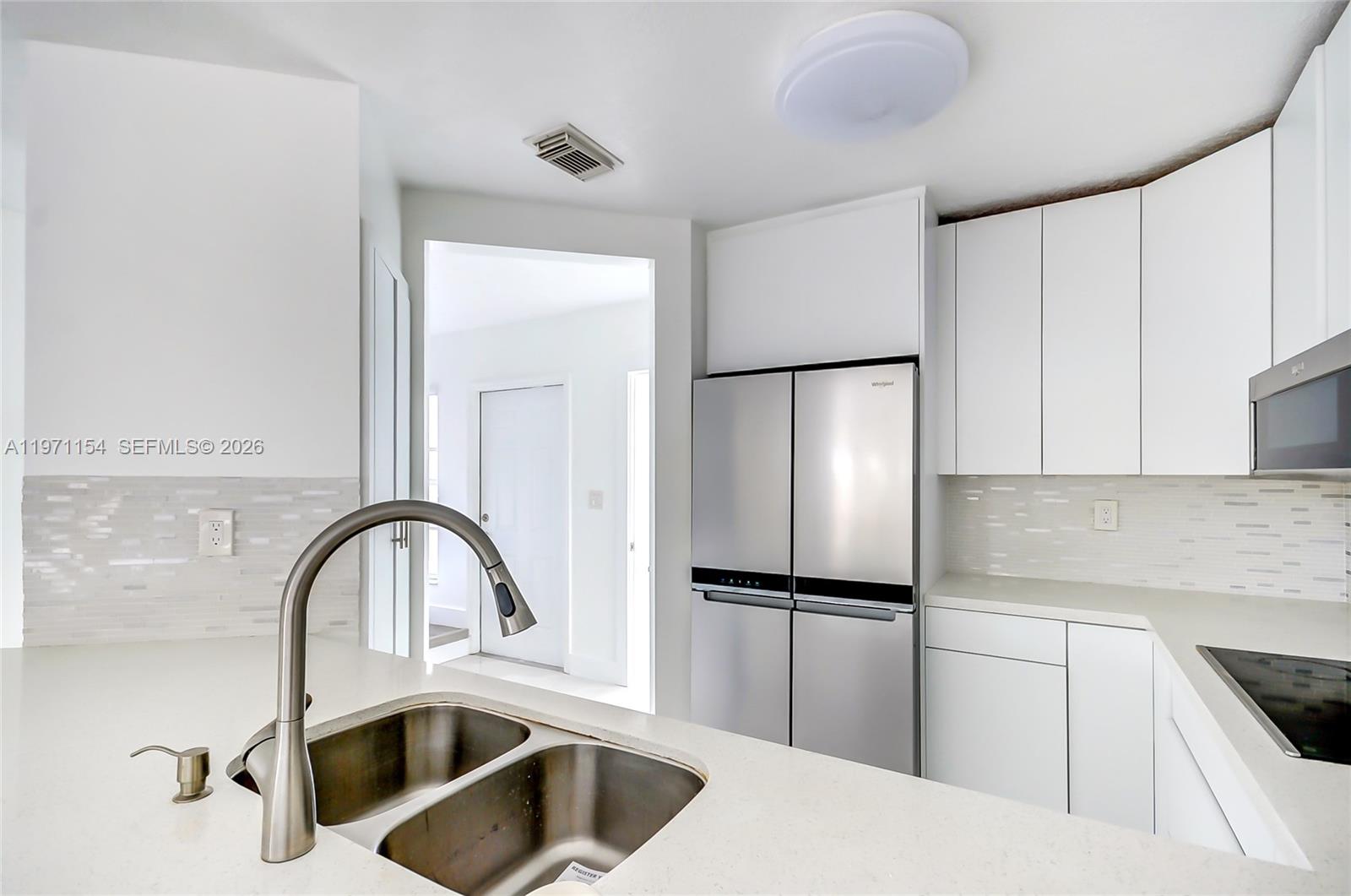 12909 Southwest 61st Terrace Miami, FL 33183 - Photo 12 of 36 a kitchen with a refrigerator and a sink