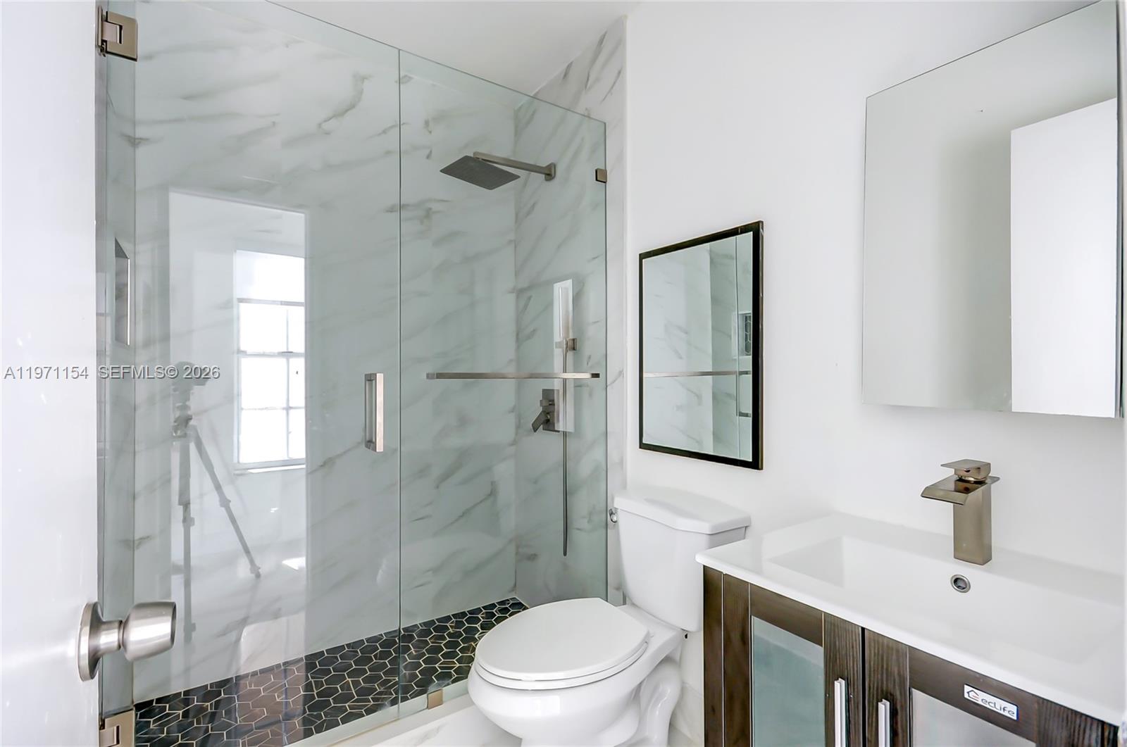 12909 Southwest 61st Terrace Miami, FL 33183 - Photo 13 of 36 a bathroom with a sink toilet and shower