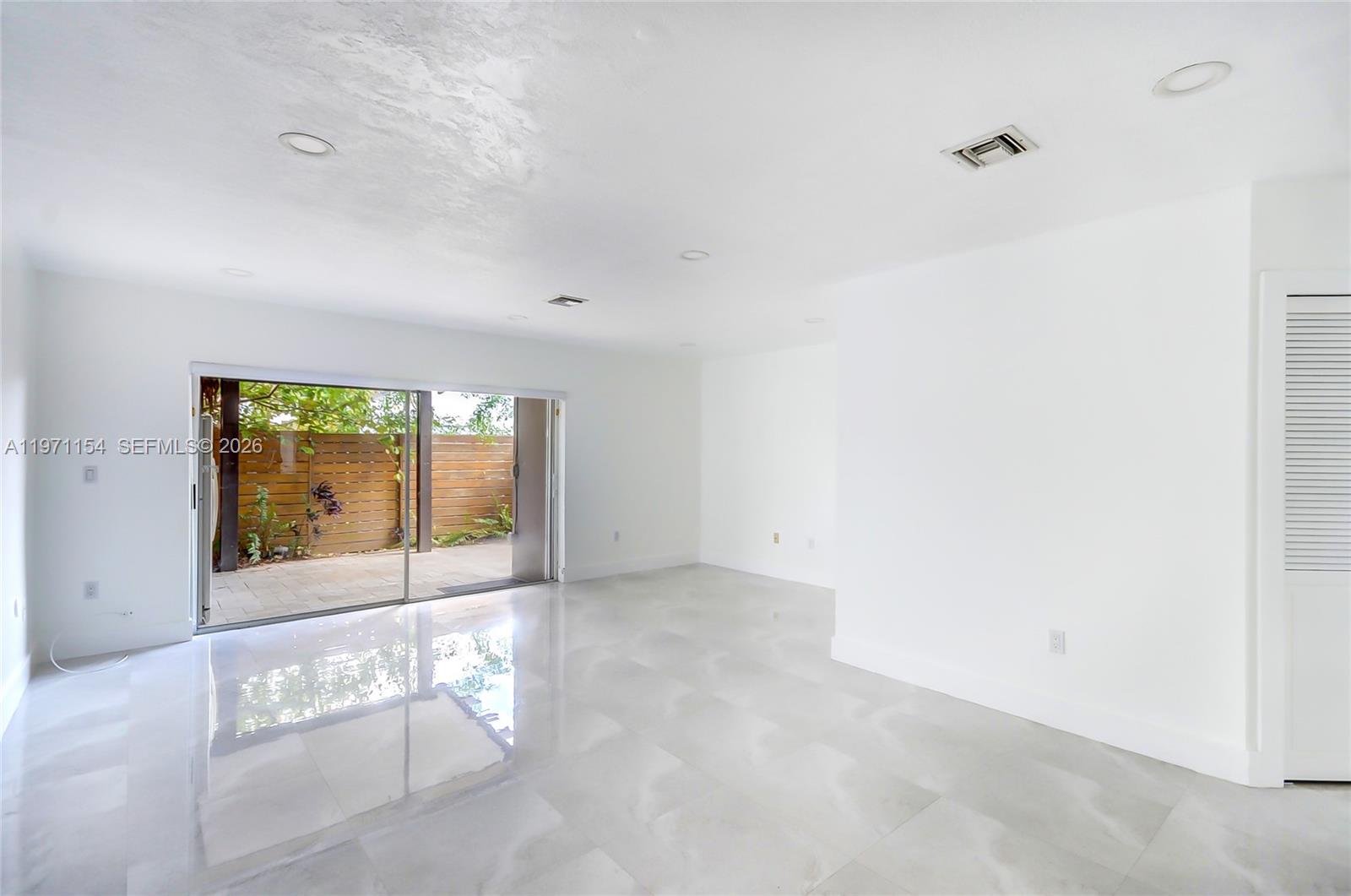 12909 Southwest 61st Terrace Miami, FL 33183 - Photo 2 of 36 a view of an empty room with a window