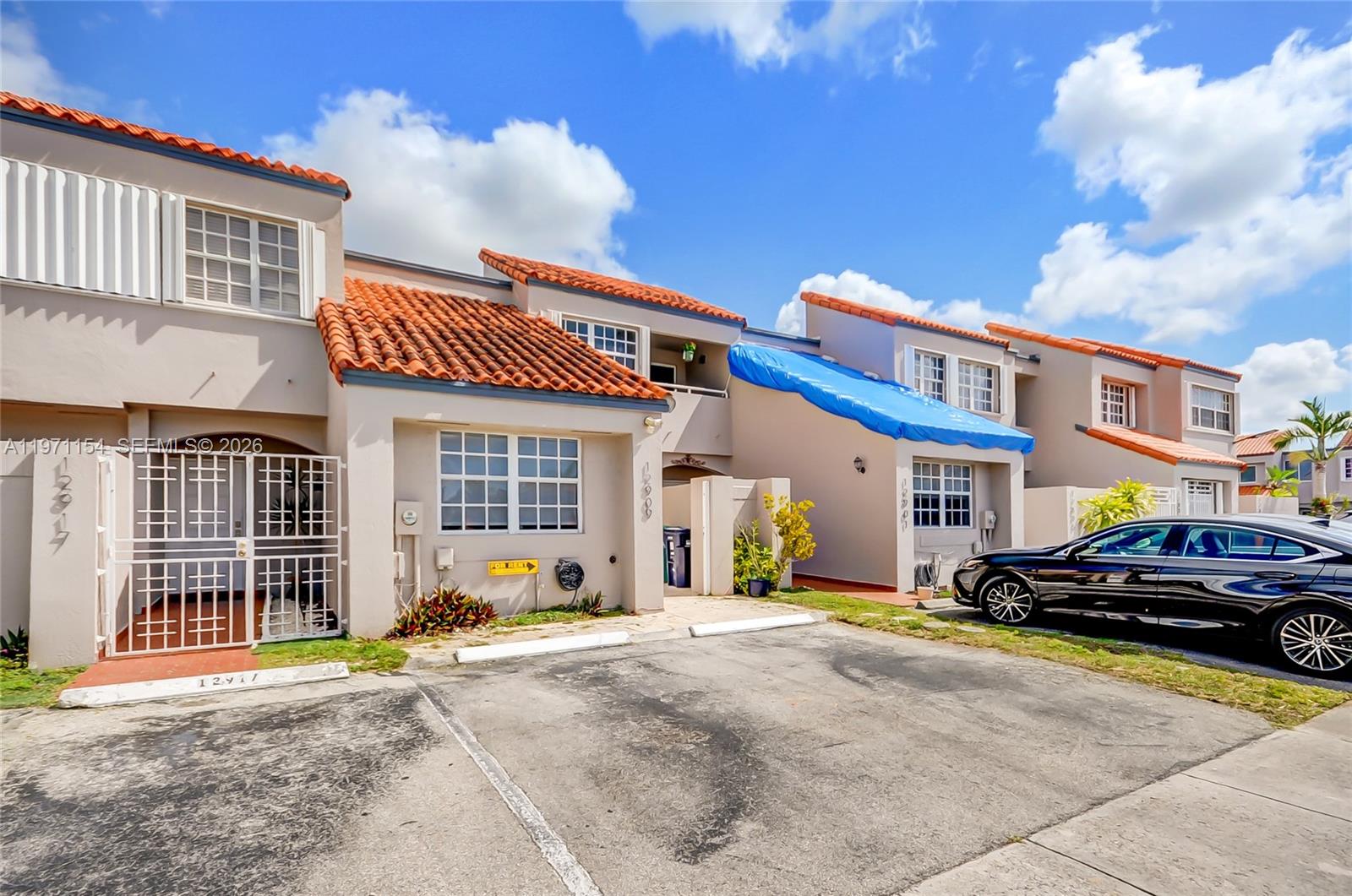 12909 Southwest 61st Terrace Miami, FL 33183 - Photo 35 of 36 a car parked in front of a house