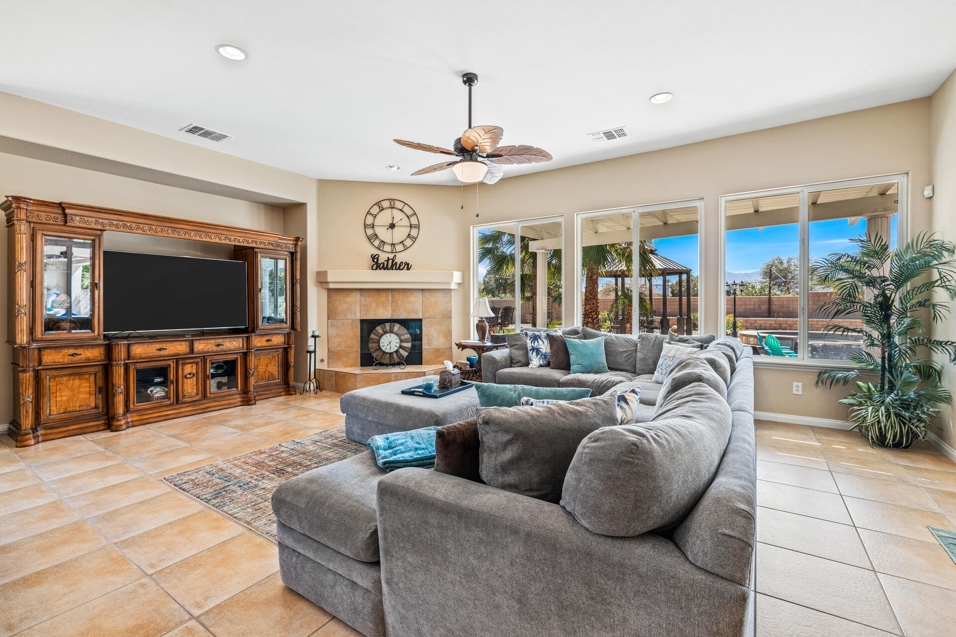 80445 Paria Way Indio, CA 92201 - Photo 29 of 70 a living room with furniture a flat screen tv and a fireplace