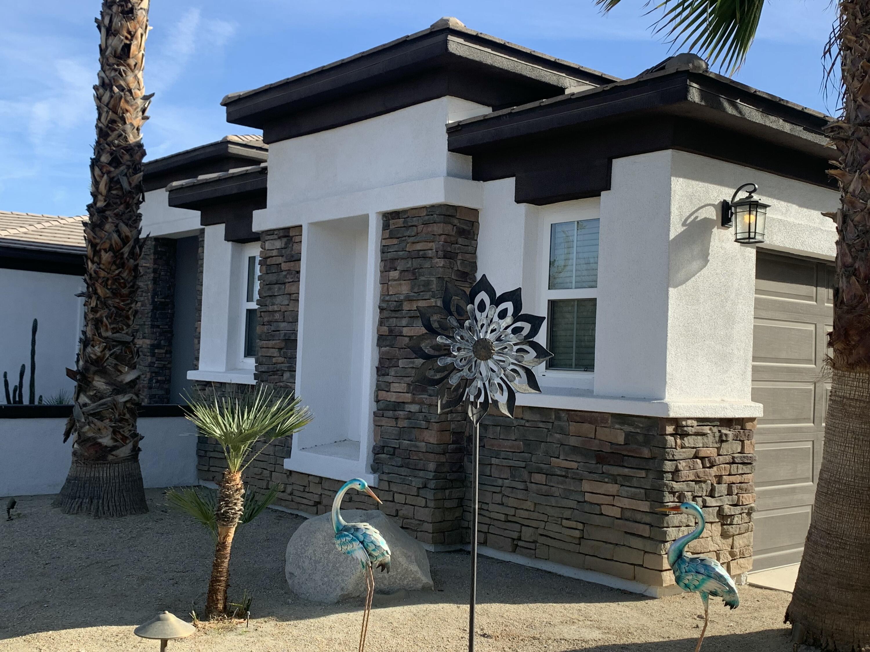 80445 Paria Way Indio, CA 92201 - Photo 3 of 70 a front view of a house with garden
