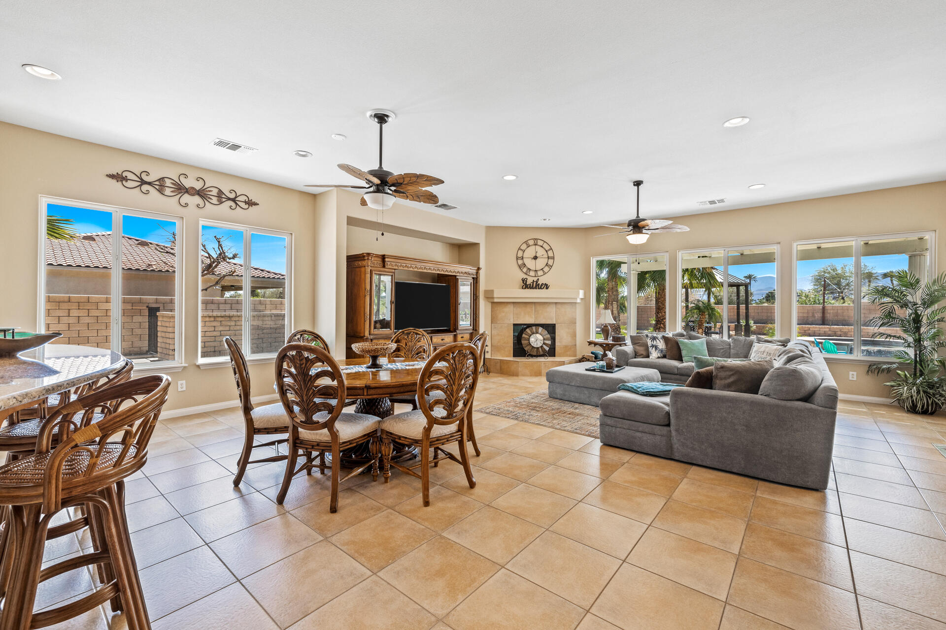 80445 Paria Way Indio, CA 92201 - Photo 33 of 70 a living room with furniture a fireplace and a flat screen tv