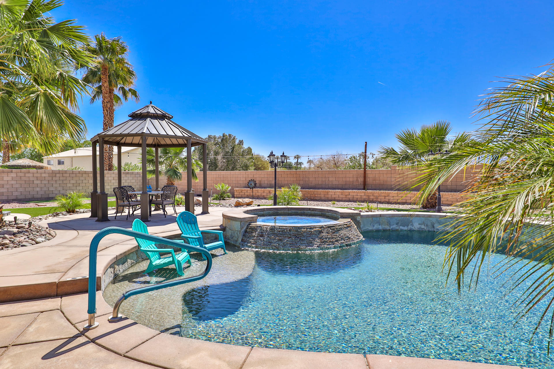 80445 Paria Way Indio, CA 92201 - Photo 36 of 70 a view of a swimming pool with a patio and a yard