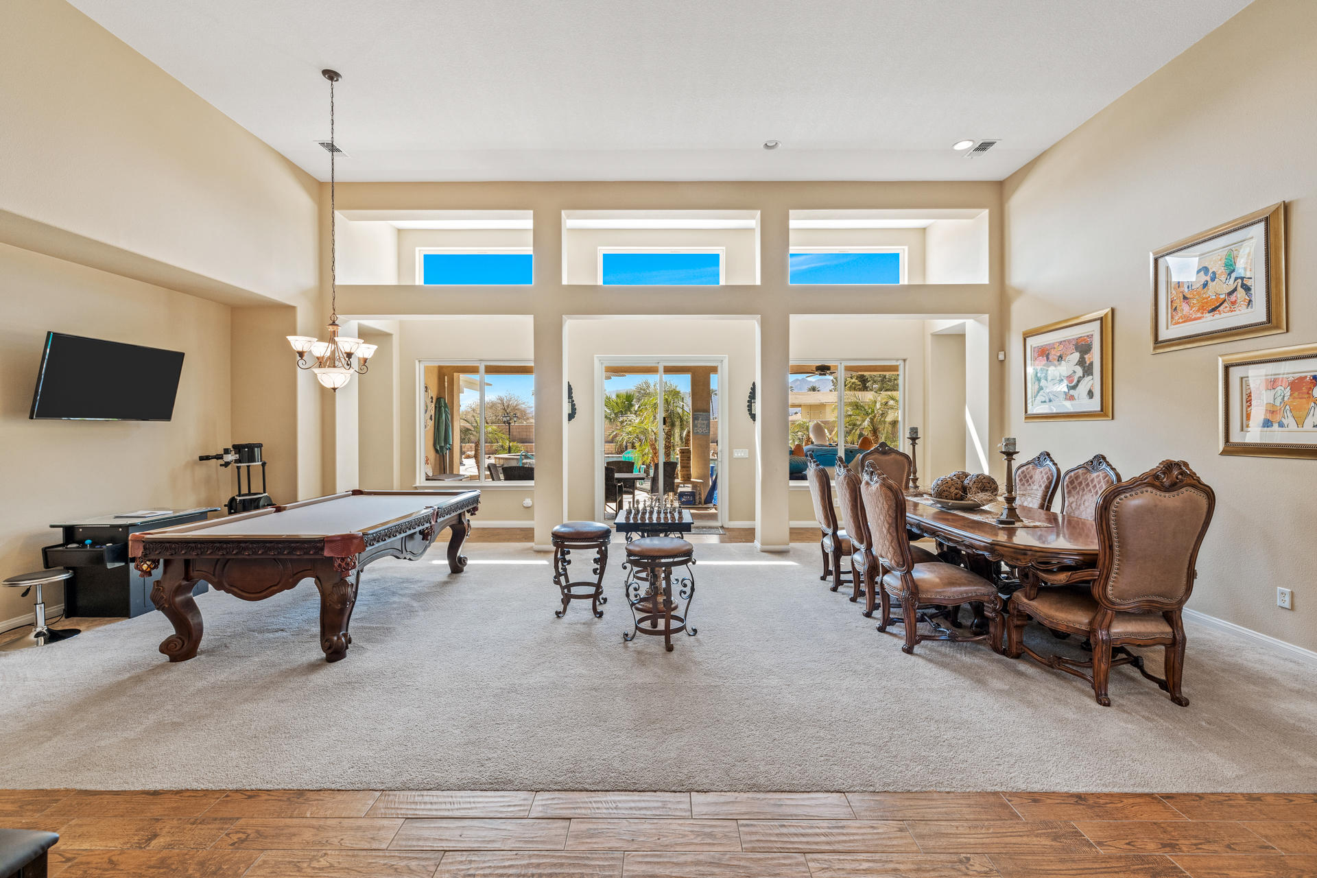 80445 Paria Way Indio, CA 92201 - Photo 5 of 70 a living room with furniture a large window and a flat screen tv