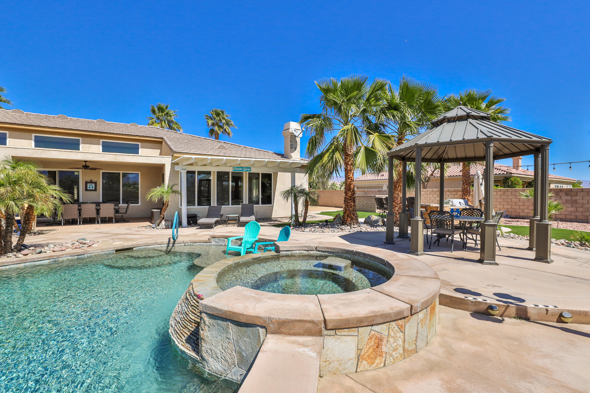80445 Paria Way Indio, CA 92201 - Photo 53 of 70 a view of a house with swimming pool and sitting area