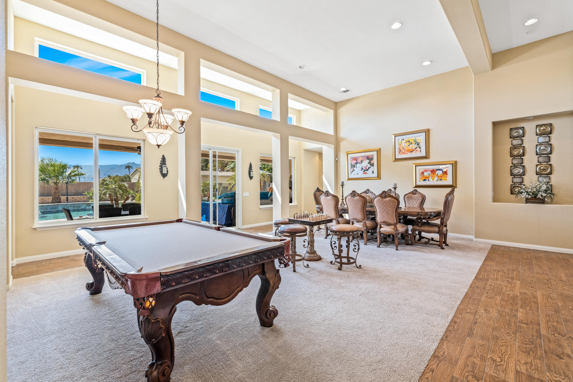 80445 Paria Way Indio, CA 92201 - Photo 10 of 70 a living room with chairs a table and painting on the wall