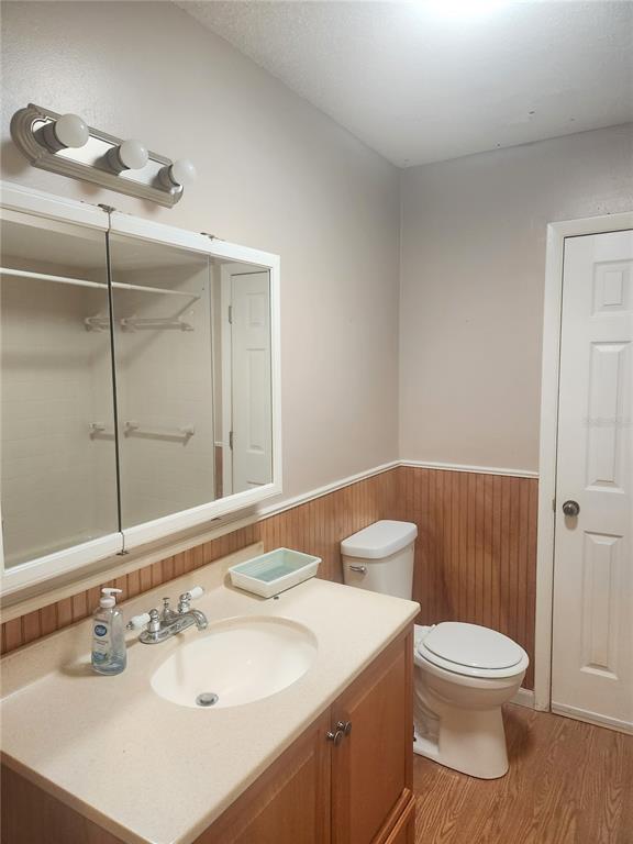 9075 Southwest 104th Lane Ocala, FL 34481 - Photo 7 of 11 a bathroom with a toilet a sink and mirror