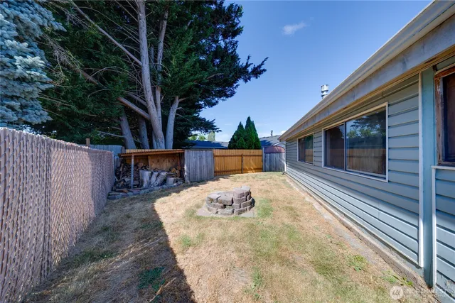 a backyard of a house with wooden floor yard and outdoor seating