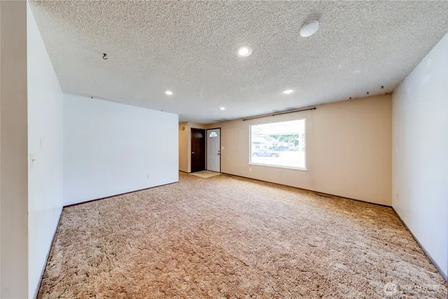 a view of an empty room and a window