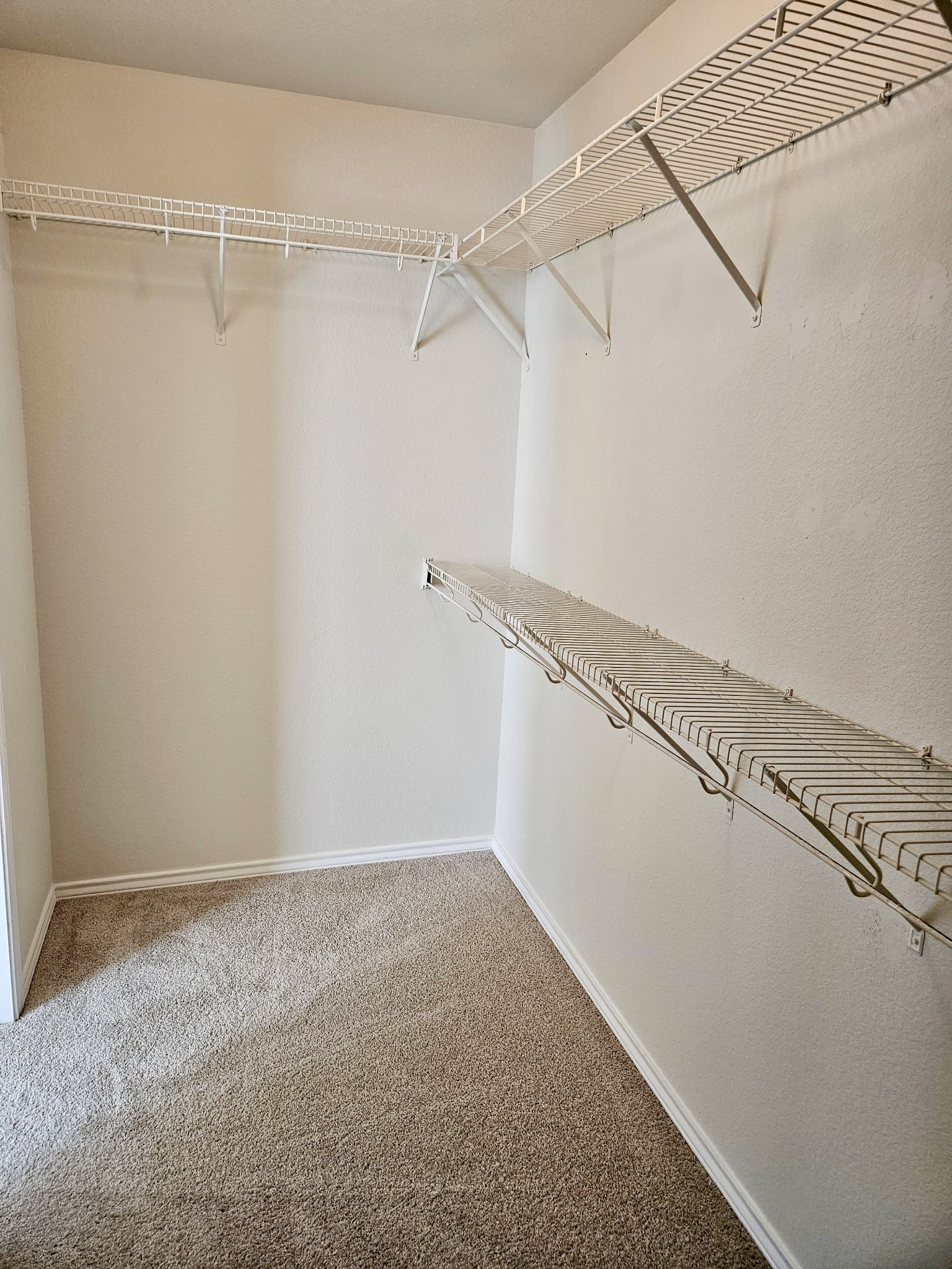 917 Sebastian Bend, Unit B Pflugerville, TX 78660 - Photo 11 of 20 a view of a room with racks on the wall