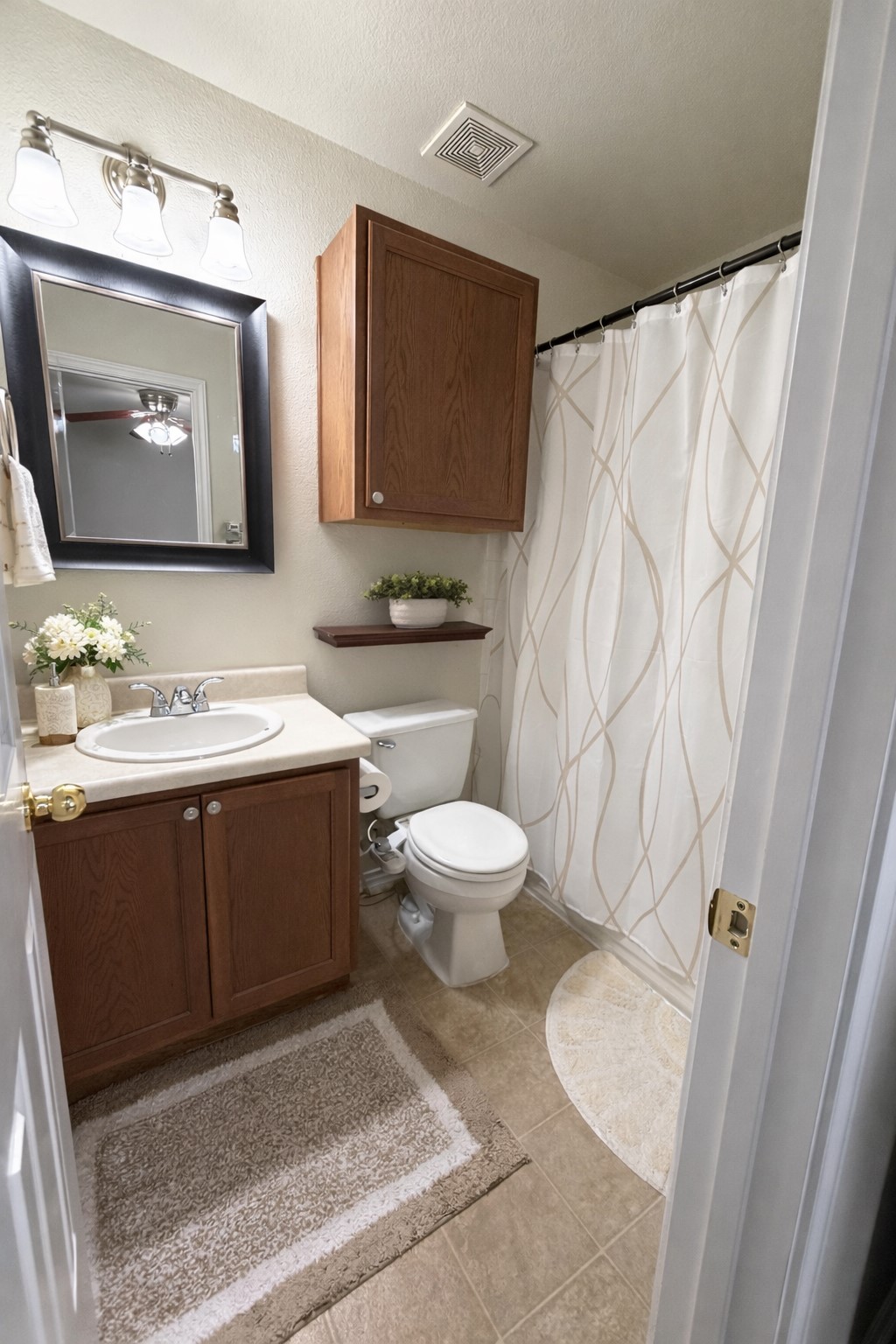 917 Sebastian Bend, Unit B Pflugerville, TX 78660 - Photo 12 of 20 a bathroom with a sink vanity mirror and toilet