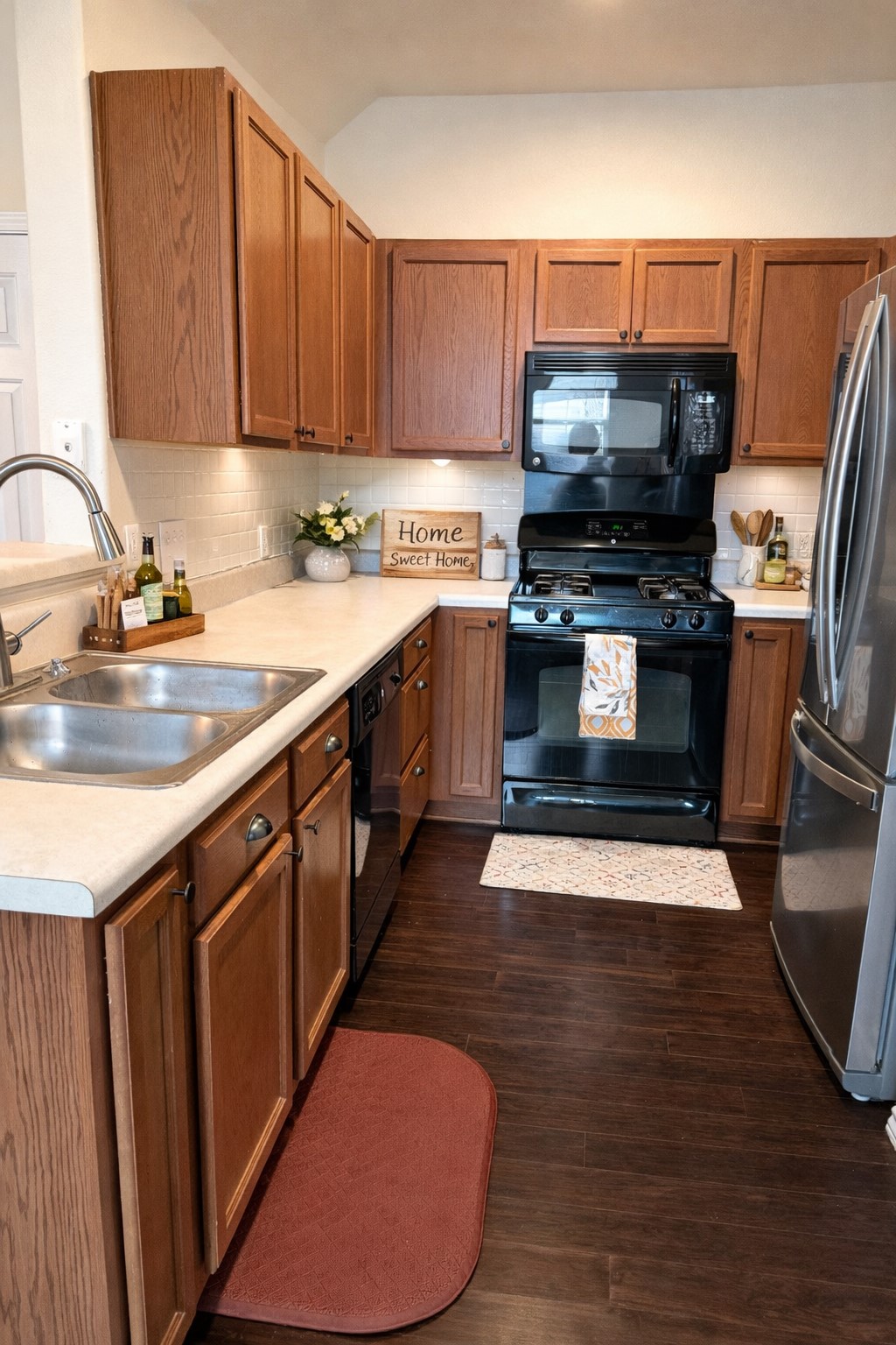 917 Sebastian Bend, Unit B Pflugerville, TX 78660 - Photo 6 of 20 a kitchen with stainless steel appliances a sink a stove top oven a refrigerator and cabinets