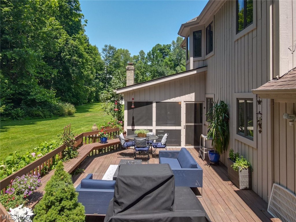 3700 Chagrin River Road Chagrin Falls, OH 44022 - Photo 37 of 43 Wooden terrace with a sunroom and a lawn