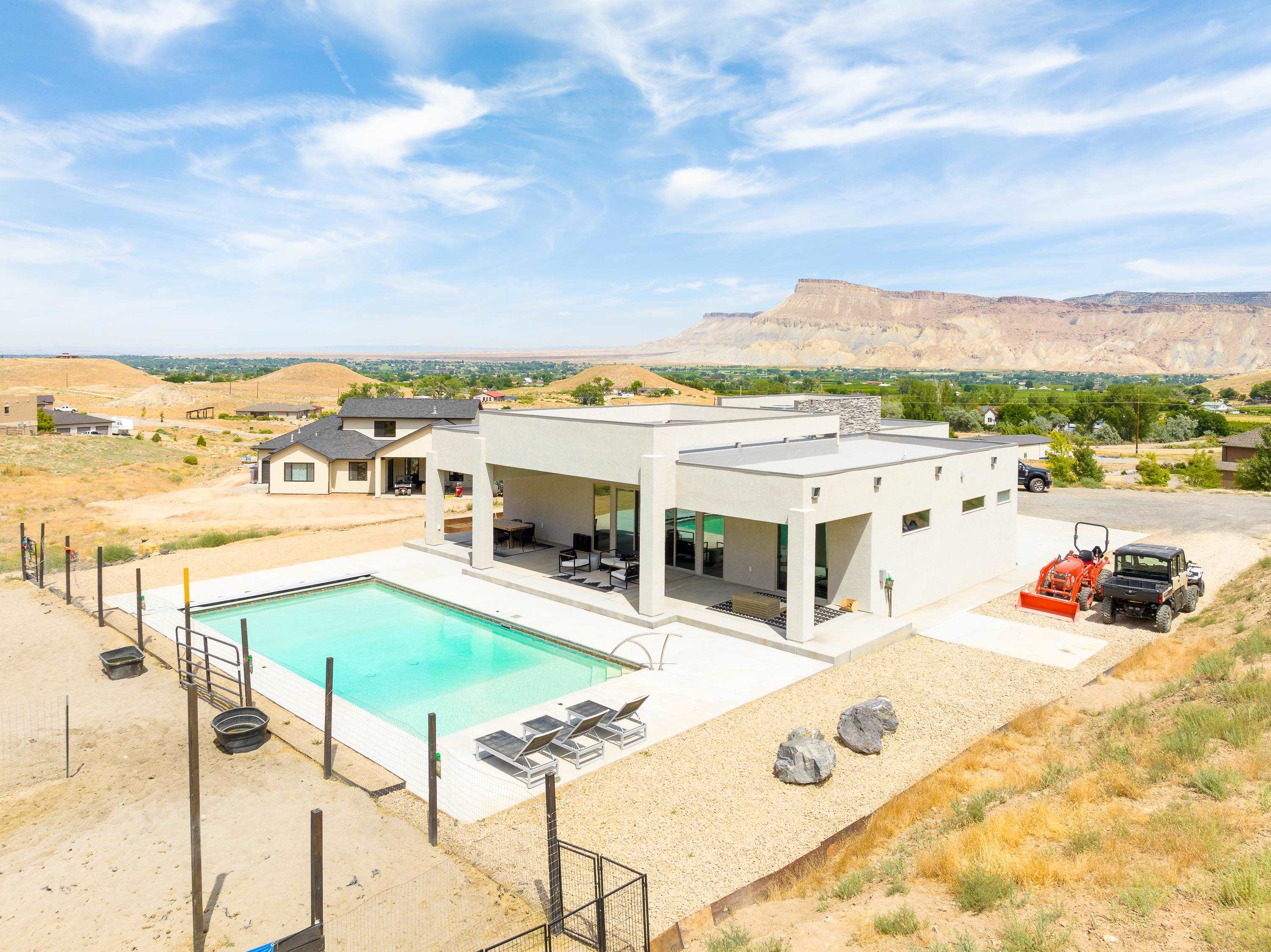 3685 East Road Palisade, CO 81526 - Photo 1 of 42 a view of a terrace with lawn chairs