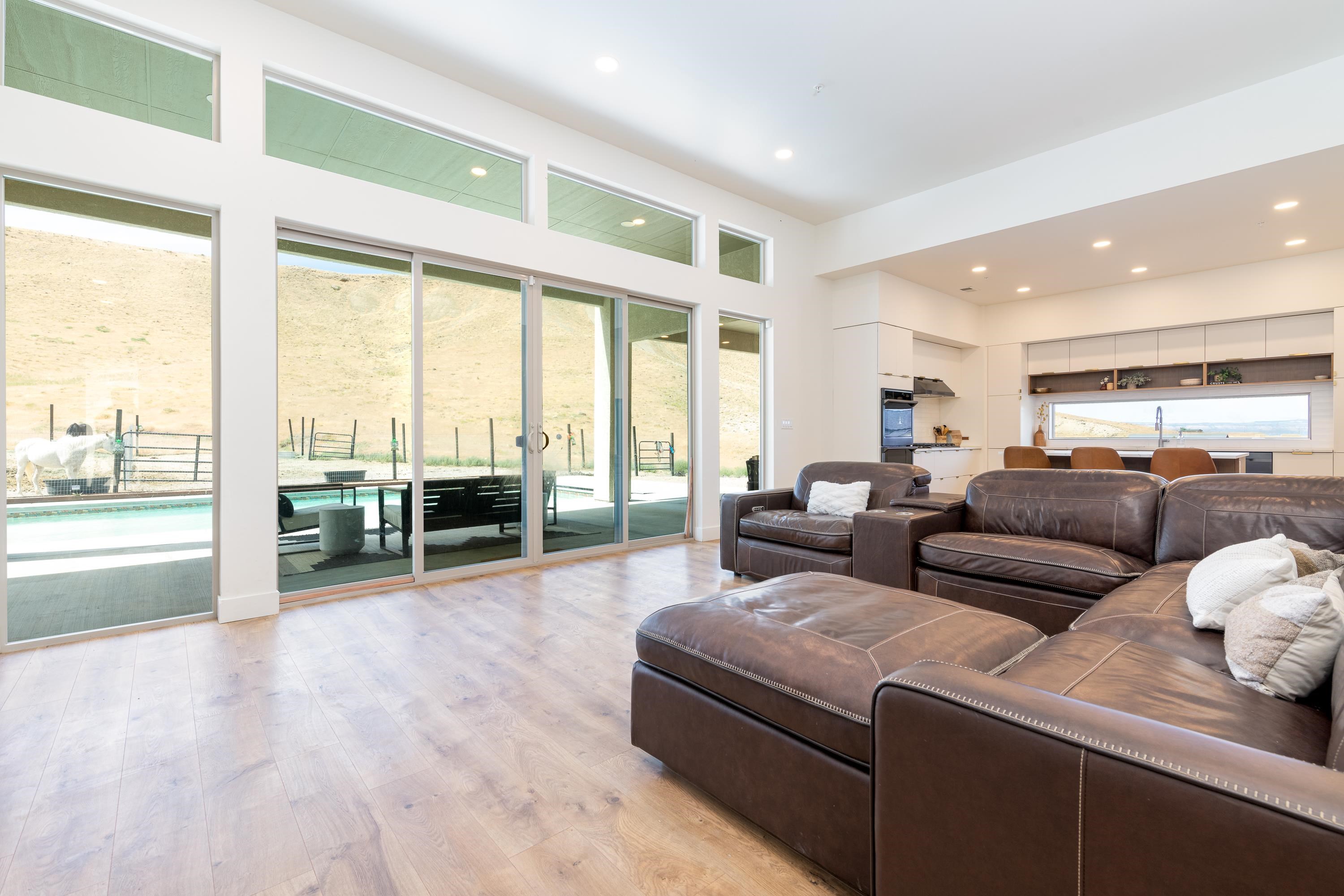 3685 East Road Palisade, CO 81526 - Photo 16 of 42 a living room with furniture and a large window with outer view