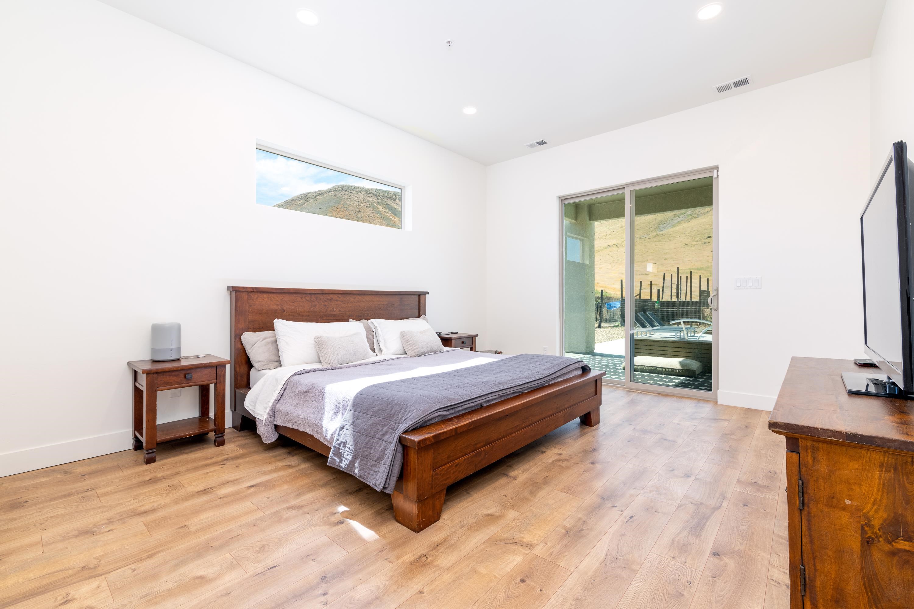 3685 East Road Palisade, CO 81526 - Photo 19 of 42 a spacious bedroom with a bed and large windows