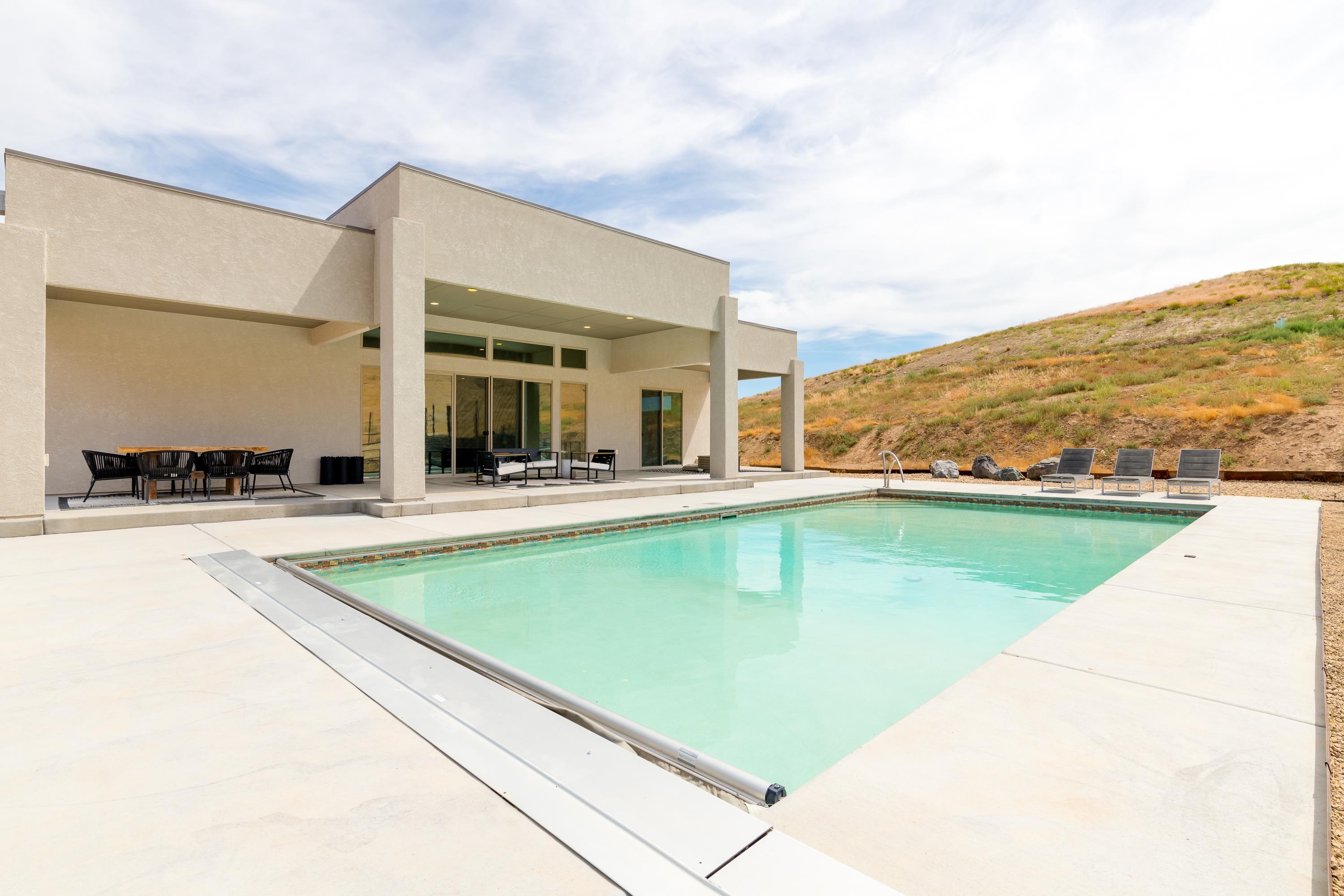 3685 East Road Palisade, CO 81526 - Photo 5 of 42 a view of a patio with swimming pool and a chairs