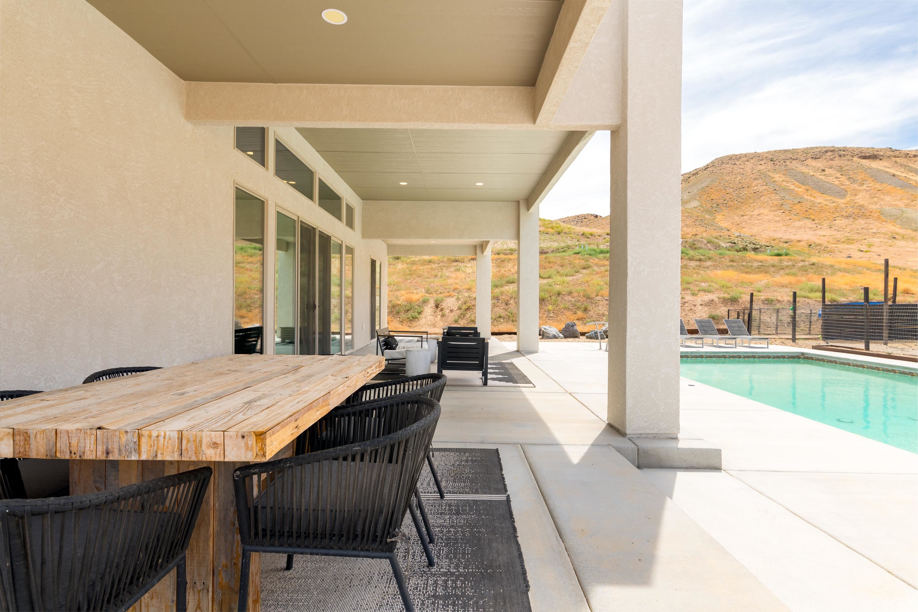 3685 East Road Palisade, CO 81526 - Photo 6 of 42 a view of a dining room with furniture large windows and wooden floor