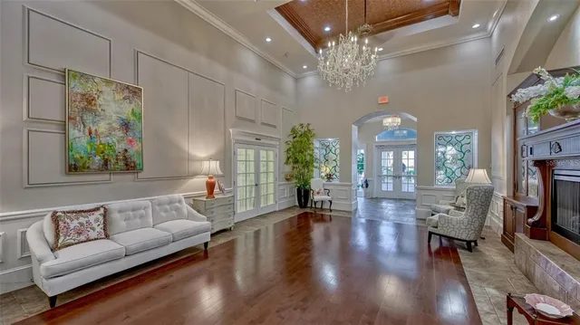 a living room with furniture and a chandelier